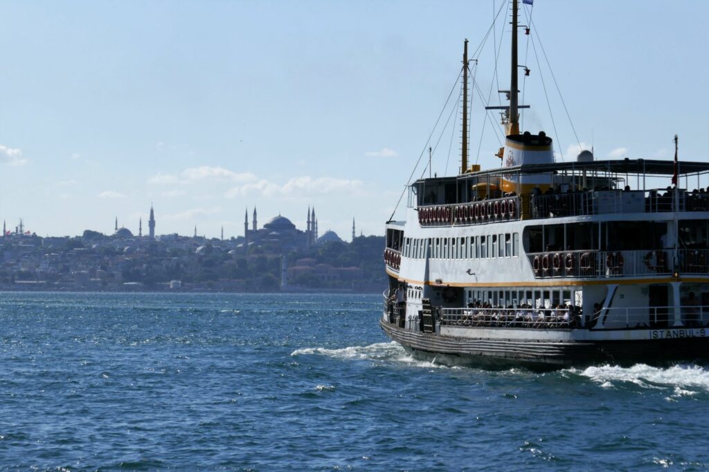 Ferry on water in Istanbul skyline